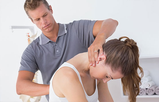 Chiroprator at Advanced Health Chiropractic in Livermore adjusting female patient's neck to relieve whiplash effects