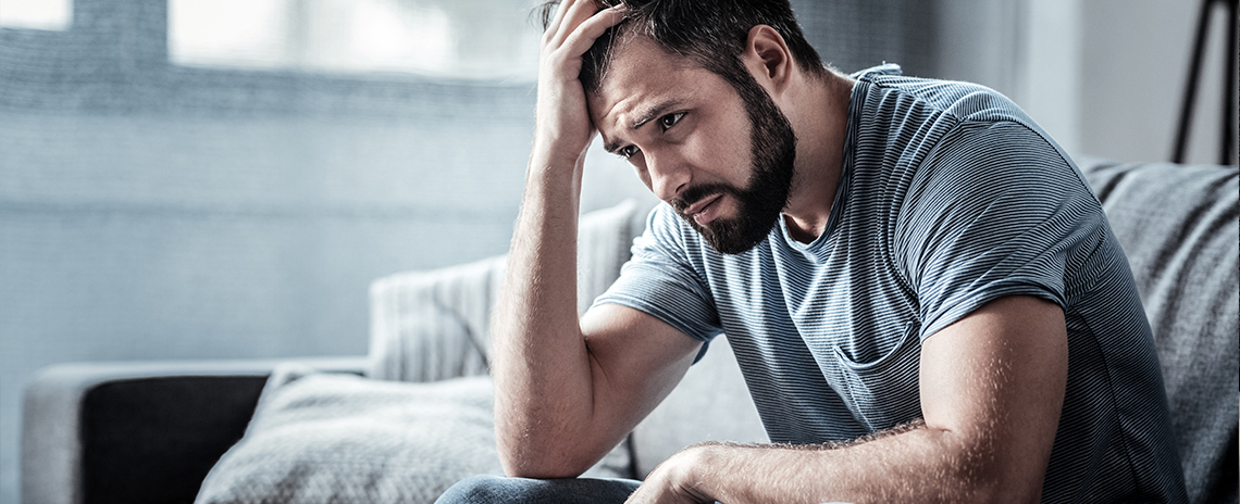Man struggling with stress at home