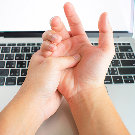 Person suffering with carpal tunnel pain in need of chiropractic care in Livermore