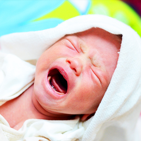 Baby crying because of colic in need of chiropractic care in Livermore