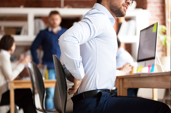 Blue collar employee suffering with lower back pain